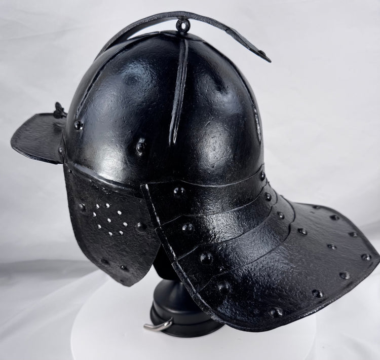Museum-quality seventeenth-century European armour helmet with fluted skull and original wing-form nasal adjustment screw.
