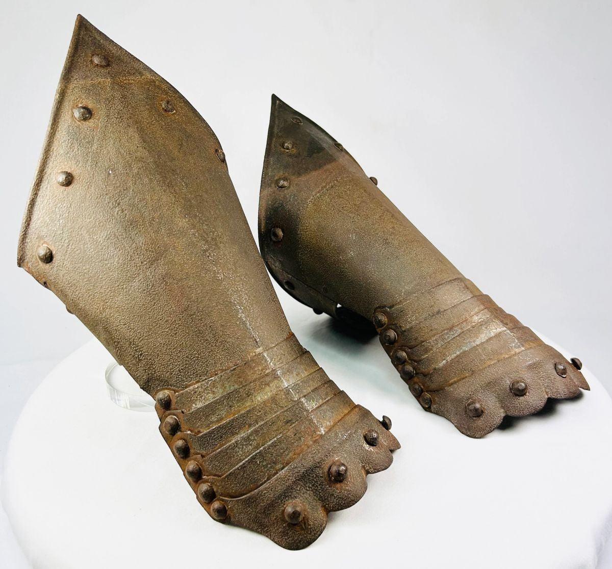air of Gothic-style steel gauntlets, likely 16th–17th century style, featuring riveted plates, flared cuffs, and subtle etched detailing; aged patina and hand-forged construction evoke authentic European medieval armor craftsmanship, once used for hand and wrist protection in battle or ceremonial display.