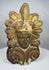 Hand-molded Greek terracotta roof ornament inspired by ancient Mediterranean architecture, featuring a human face and ornate palmette design.