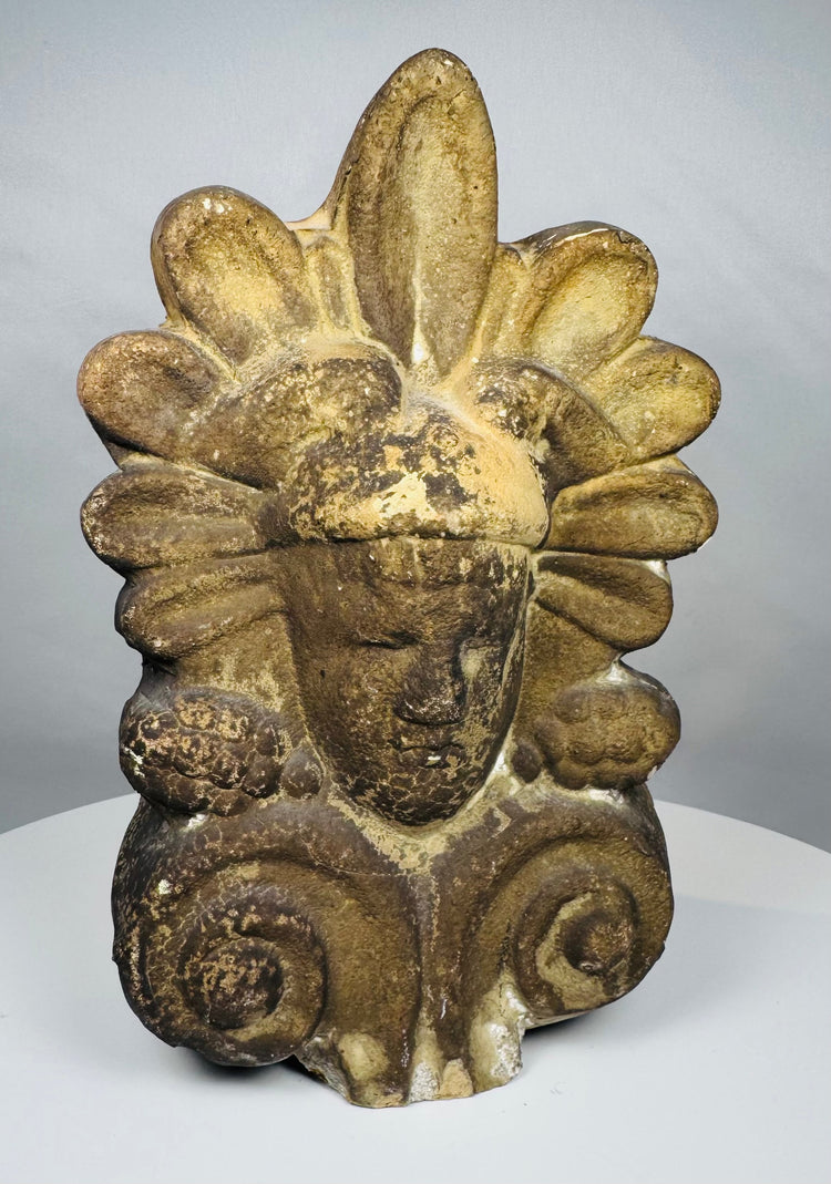 Hand-molded Greek terracotta roof ornament inspired by ancient Mediterranean architecture, featuring a human face and ornate palmette design.