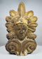 Antique Greek terracotta roof ornament featuring a classical face framed by decorative volutes and a radiating palmette motif.
