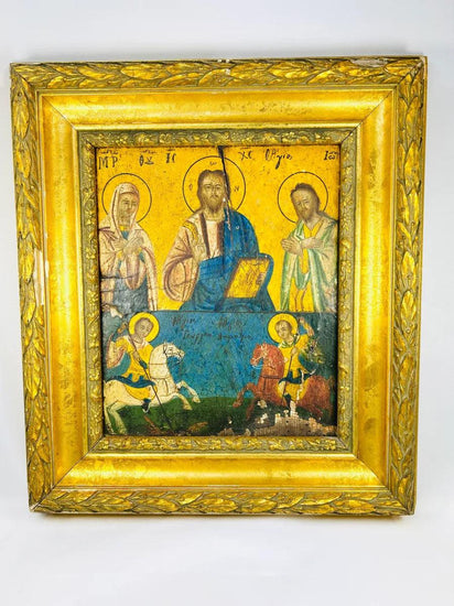 Greek Orthodox icon painting with Christ Pantocrator, Virgin Mary, and St. John the Baptist in the upper register, St. George slaying the dragon, and St. Demetrius on horseback in the lower register, painted in tempera with gold background, framed in ornate gilt foliate frame, photographed on a white background.