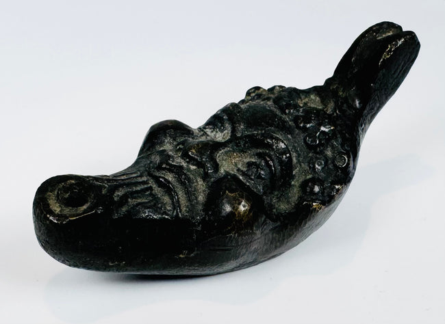 Grotesque satyr head oil lamp from Europe with aged surface patina and compact display size.
