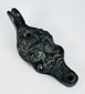 European figural oil lamp depicting a stylized satyr mask with pronounced facial features and beard.