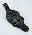 European figural oil lamp depicting a stylized satyr mask with pronounced facial features and beard.