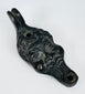 European figural oil lamp depicting a stylized satyr mask with pronounced facial features and beard.