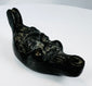 Antique mythological mask oil lamp featuring exaggerated eyes, beard, and cast metal craftsmanship.