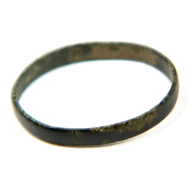 Ancient plain bronze finger band with dark patina and simple narrow profile, Roman to Early Byzantine period