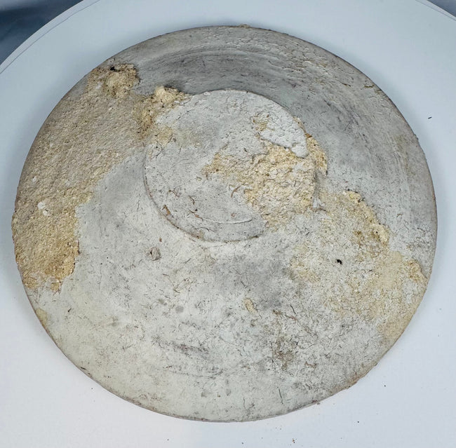 Close-up of the larger Ancient Roman North African Kassérine bowl showing white slip surface and archaeological wear.
