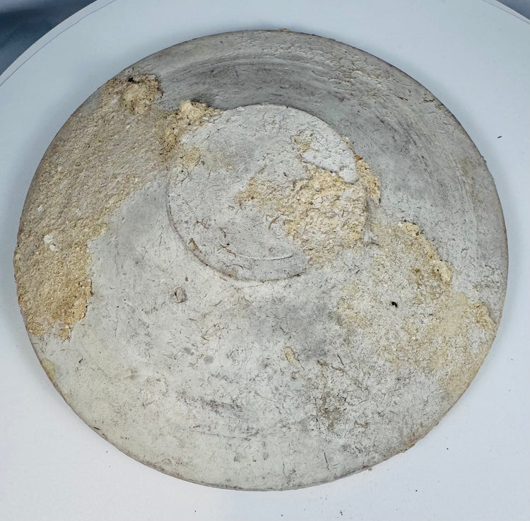 Close-up of the larger Ancient Roman North African Kassérine bowl showing white slip surface and archaeological wear.