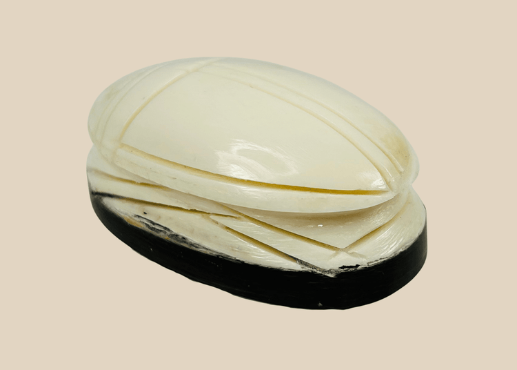 Antique East Asian carved bone scarab talisman on dark oval base, late 19th to early 20th century protective charm