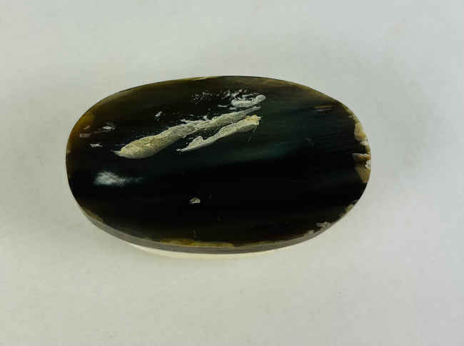 Bottom view of protective East Asian scarab talisman showing craftsmanship and fine carved surface texture