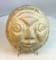Primitive-style carved stone head showing natural stone coloration and aging