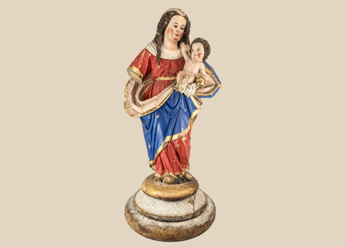 Spanish Colonial Madonna and Child statue, circa 1780–1820, hand-carved wood with original polychrome and gilding. Virgin in red and blue robes with gilt highlights holds infant Christ with golden orb. Mounted on original socle with craquelure and age wear.