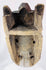West African ritual mask featuring symbolic facial motifs, recessed eyes, and carved headdress crest.