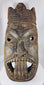 Traditional African ceremonial mask with elongated nose, projecting tongue motif, and carved headdress.