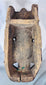 Traditional tribal mask with carved teeth, prominent nose, and dark aged hardwood construction.