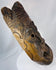 Ethnographic West African hardwood mask displaying bold spiritual imagery and weathered surface pigmentation.