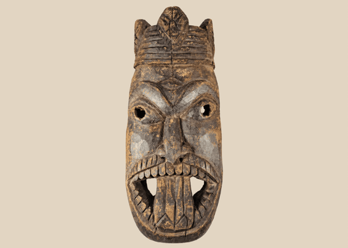 Antique West African ceremonial mask with carved third eye, open mouth, and expressive tribal features.