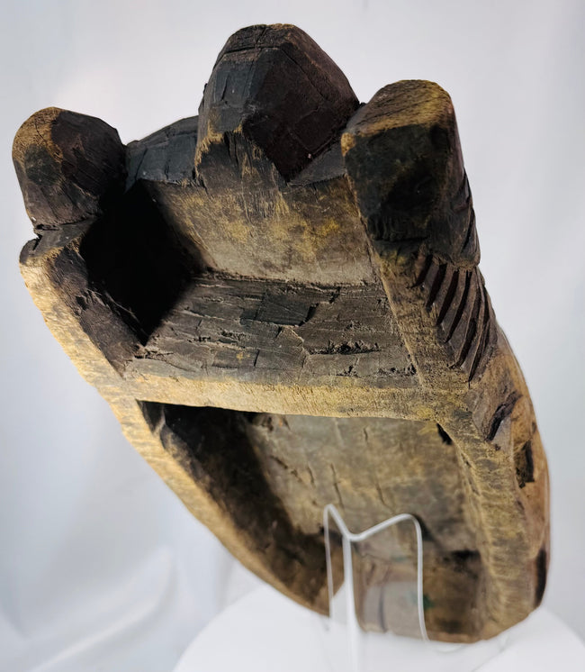 Historic African ceremonial mask with hand-carved details, weathered pigment, and spiritual symbolism.
