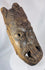 Antique tribal mask from West Africa with stylized facial features and deeply hollowed hand-carved interior.