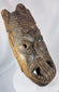 Antique tribal mask from West Africa with stylized facial features and deeply hollowed hand-carved interior.