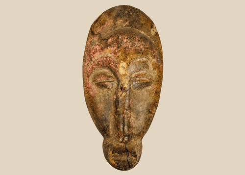 West African Baule style wooden mask with elongated face and pigment