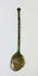 Top-down view of ancient bronze spoon with narrow handle and circular bowl, aged bronze patina.