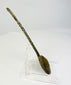 Right side profile of ancient bronze spoon displaying corrosion and natural verdigris from age.