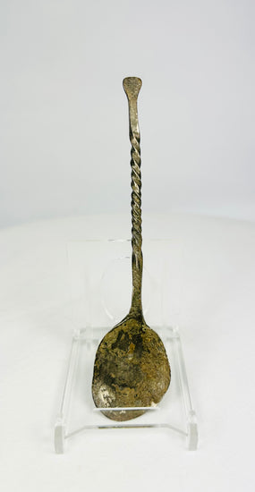 Hand-forged bronze spoon with twisted handle on white background, circa 2nd century AD