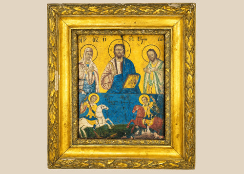 Greek Orthodox icon painting with Christ Pantocrator, Virgin Mary, and St. John the Baptist in the upper register, St. George slaying the dragon, and St. Demetrius on horseback in the lower register, painted in tempera with gold background, framed in ornate gilt foliate frame, photographed on a white background.