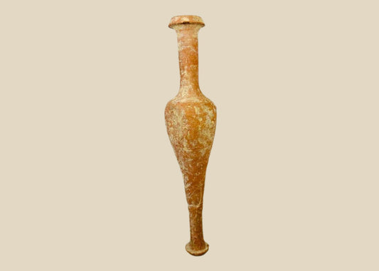 Ancient Hasmonean terracotta bottle from Judea, circa 300–100 BCE. Slender neck with narrow mouth, elongated rounded body, and naturally aged patina. Mounted on a later marble base for display. Functional and elegant vessel used for oils, perfumes, or sacred substances, reflecting daily life and material culture of ancient Judea.