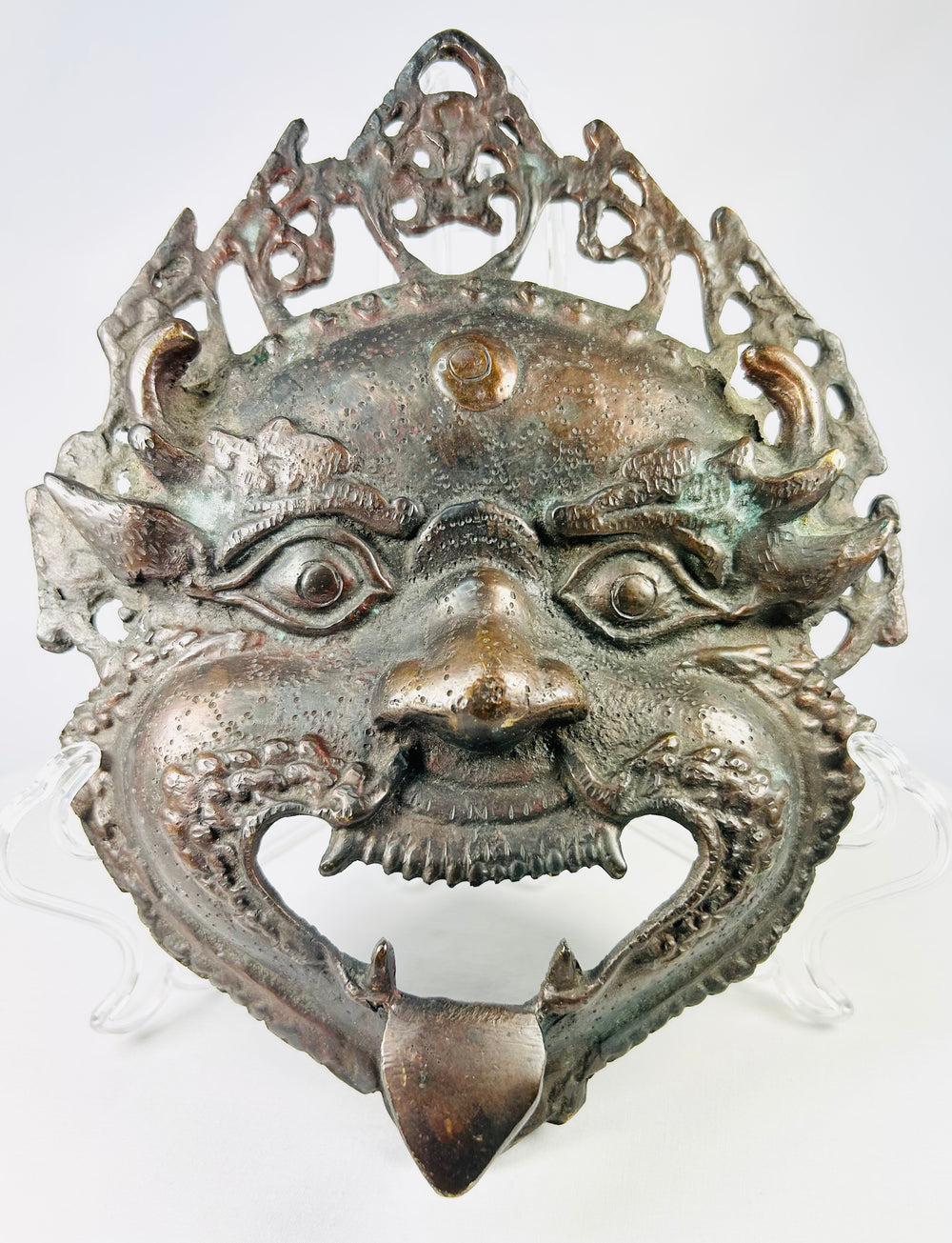 Himalayan ritual bronze mask depicting a fierce protective deity, Nepal or Northern India, late 19th–early 20th century
