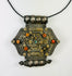Hexagonal Himalayan gau (ghau) amulet pendant in silver-tone alloy with parcel-gilt filigree, rosette appliqués, inset coral beads, and small turquoise cabochon, featuring hollow reliquary cavity and tubular suspension bales, late 19th–early 20th century, Tibet/Nepal