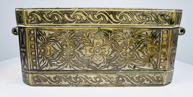 Opposite end of the Philippine betel box showing engraved ornament, metal construction, and original fastening hardware.