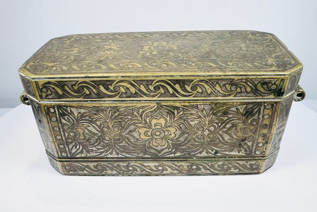 Late 18th to early 19th-century Philippine betel nut box with intricate brass floral inlay and aged mixed-metal surface.