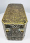 Top of a Philippine betel nut box displaying dense floral scrollwork and symmetrical brass-inlaid decoration across the lid.