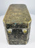 Side of a Mindanao betel nut box with ornate brass-inlaid floral motifs and naturally aged dark metal patina.