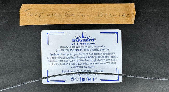 Reverse of conservation-framed American military document with archival labels