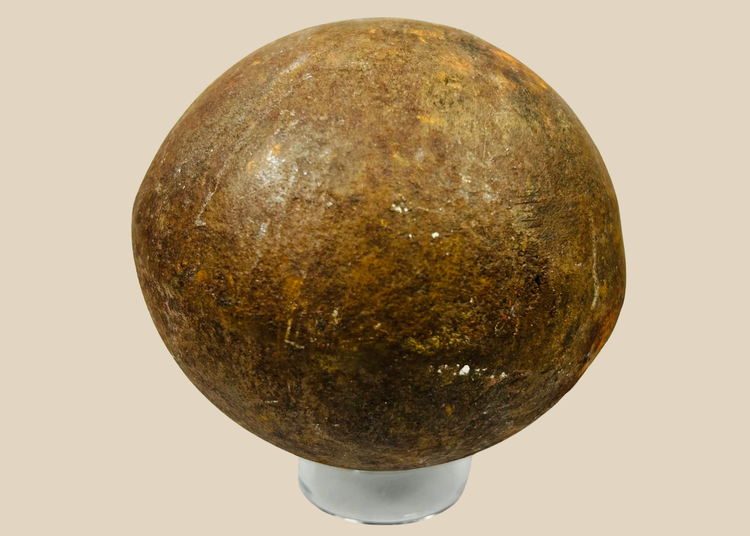 Antique solid iron cannonball with heavy patina, 18th–19th century artillery shot