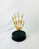 Historic medical teaching model of a human skeletal hand on hardwood base