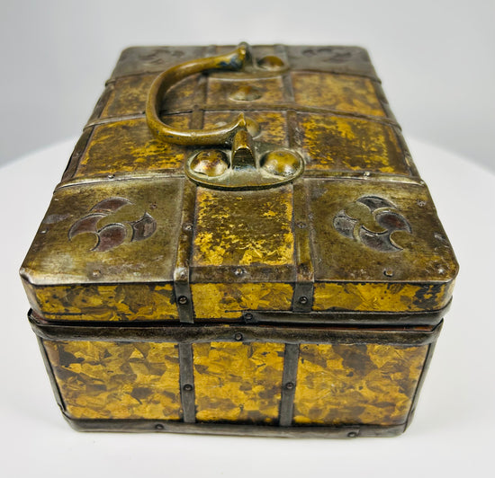 Early 1800s Eastern European jewelry casket with iron straps, riveted construction, and decorative gilt metal panel covering.