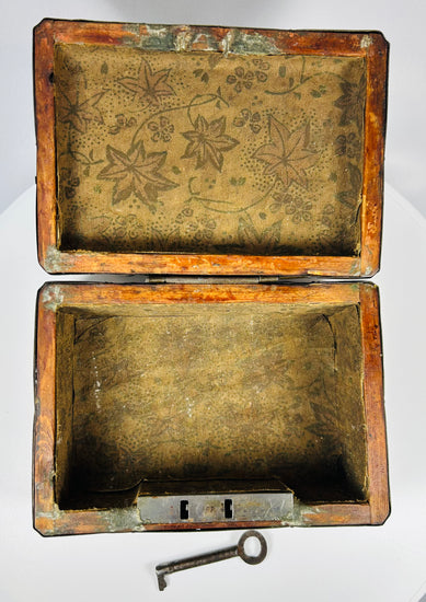 Early 19th century Eastern European decorative iron strongbox with riveted straps and gilt metal tortoiseshell style panels.