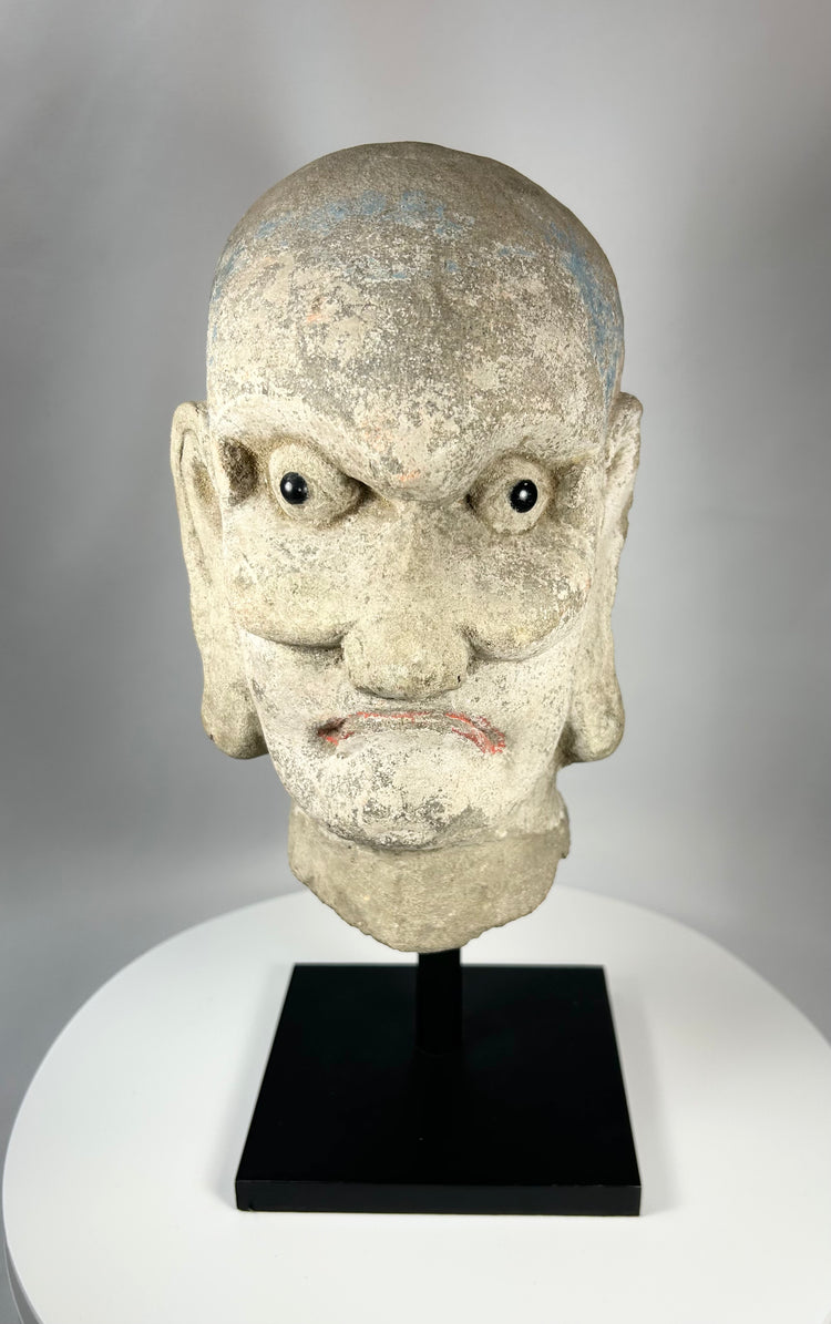 Antique Chinese Buddhist Luohan stone head sculpture with faint blue and red pigment, Qing Dynasty.