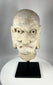 Antique Chinese Buddhist Luohan stone head sculpture with faint blue and red pigment, Qing Dynasty.