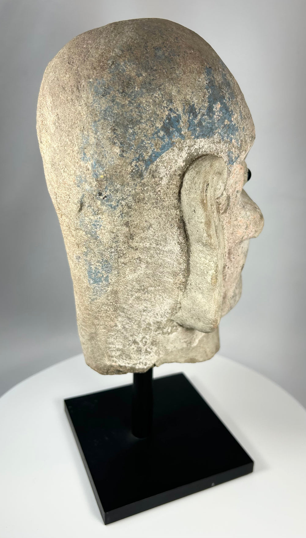 Qing Dynasty carved stone Luohan head with pronounced brows and expressive facial features.