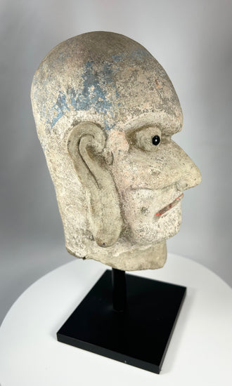 Chinese Buddhist Arhat stone head sculpture with remnants of original temple polychrome.