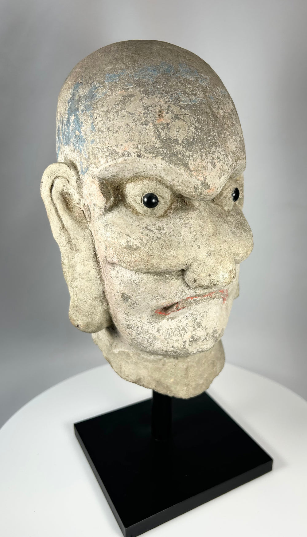 Antique Chinese stone head of a Luohan disciple from the Qing Dynasty, circa 18th–19th century.