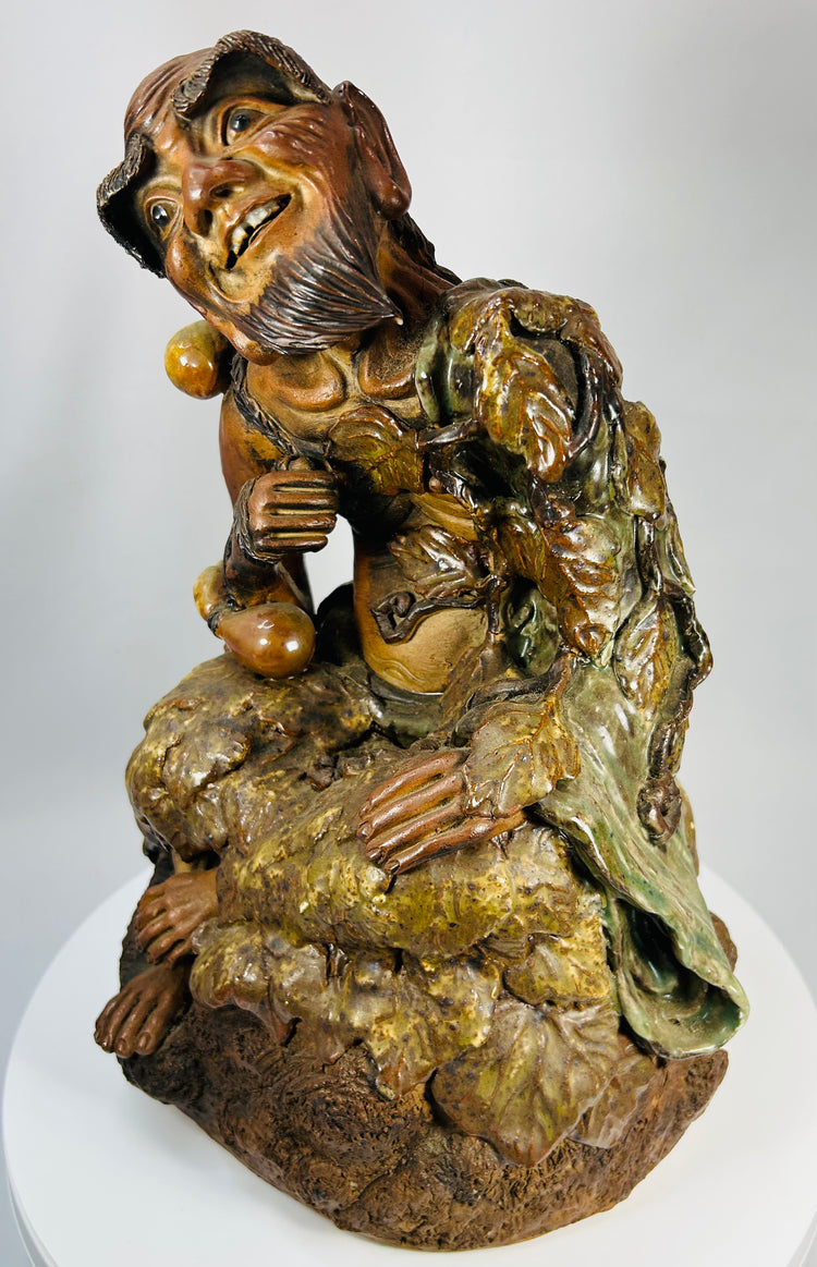 Antique Chinese ceramic sculpture of the Mad Monk Jigong seated with vine leaf robe and gourd vessels.