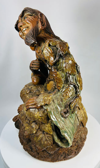 Antique Chinese temple sculpture of Jigong with naturalistic vine leaves and gourds.